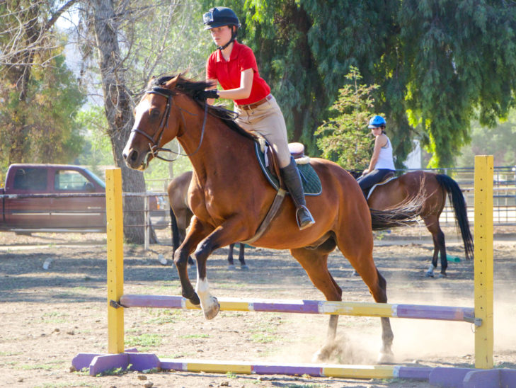 A camper participating in English riding.