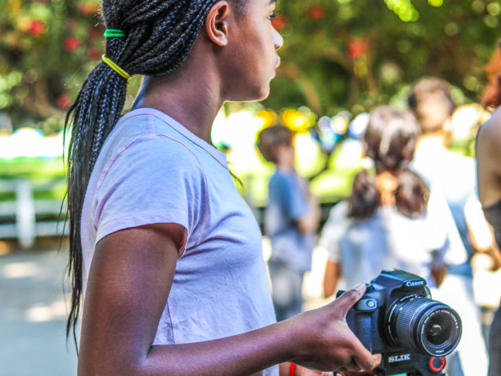 A camper setting up her camera for a photo.