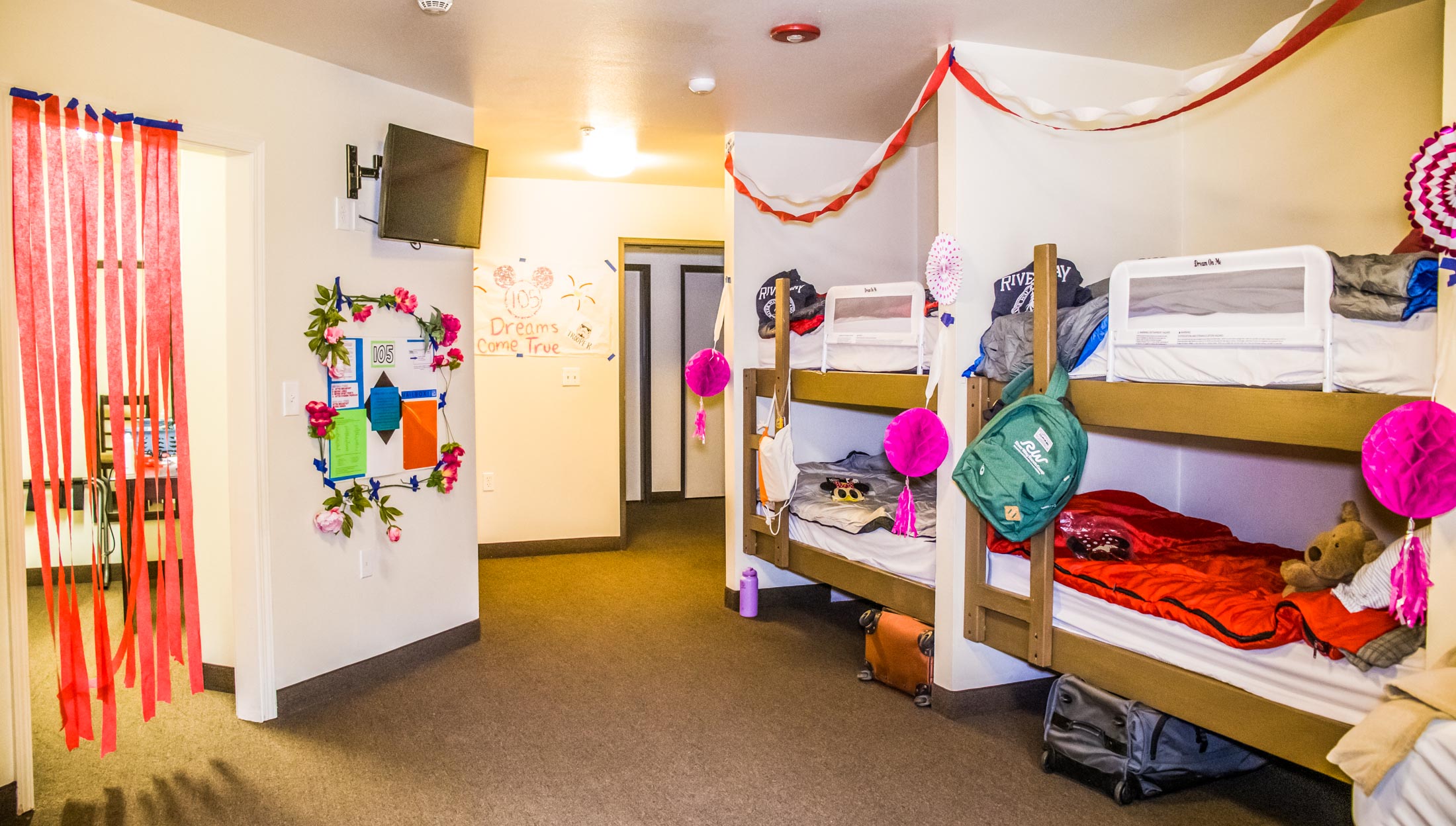 A view of a room in a cabin with bunks.