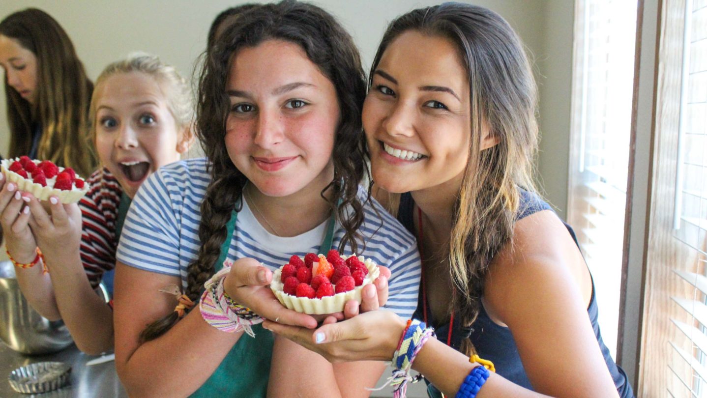 CITs holding up small fruit pies