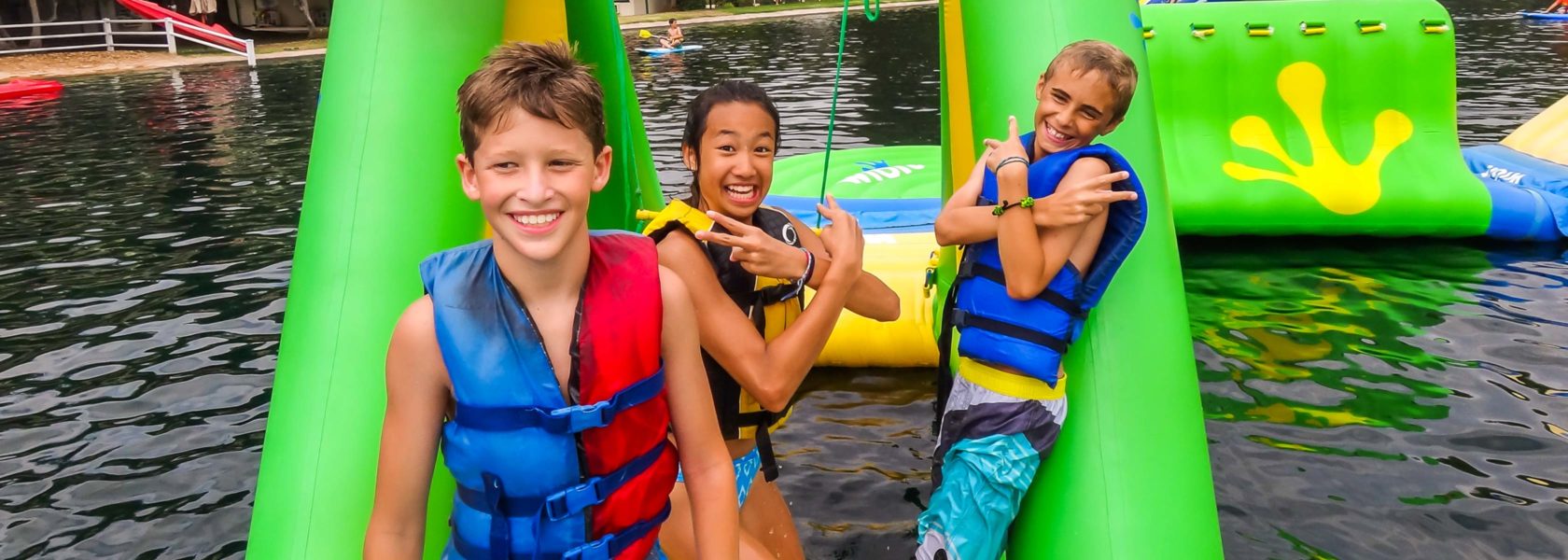 Campers playing on the water adventure course