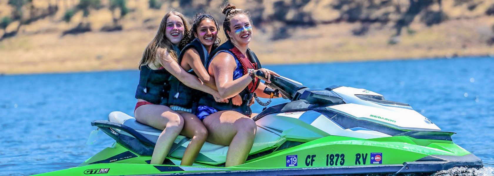 Campers on a jetski in the lake