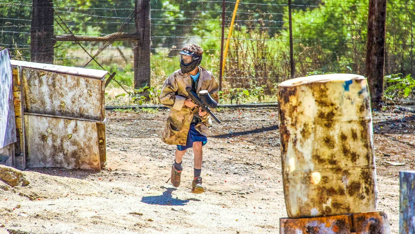 A camper running on the paintball course