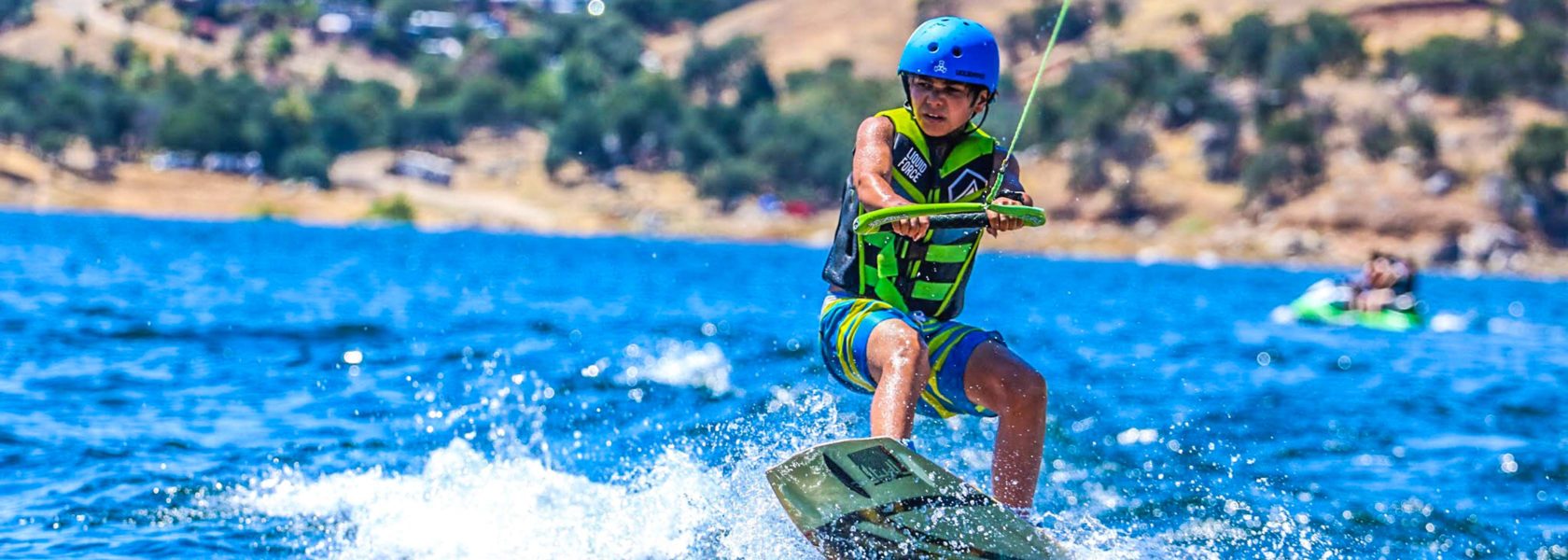 A camper wakeboarding in the lake