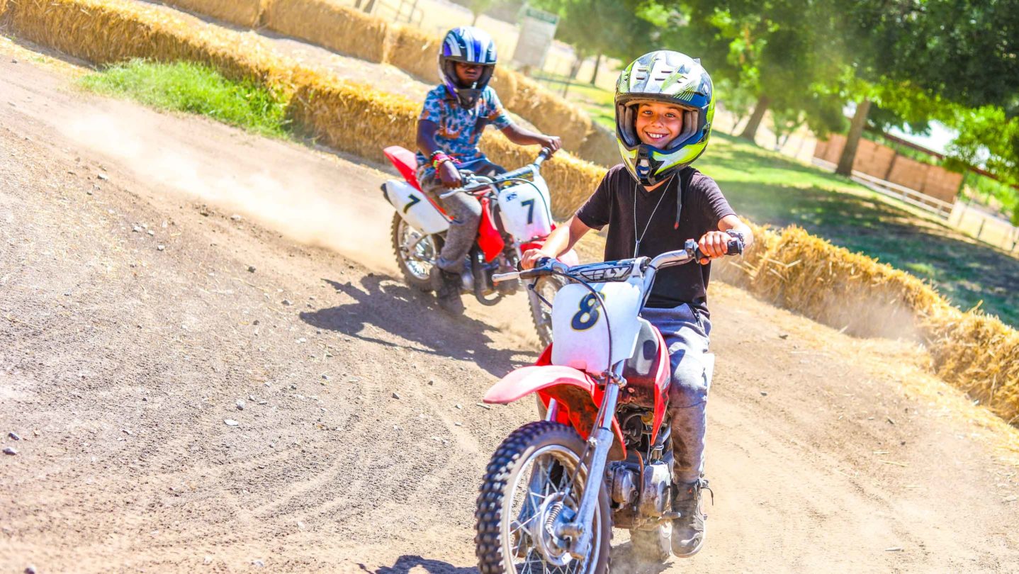 Campers riding mini bikes