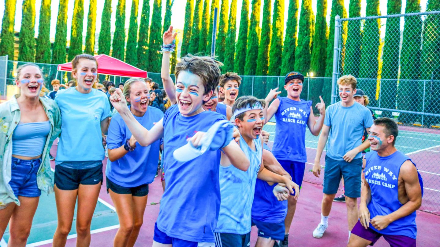 Campers dancing and jumping on the tennis courts