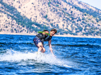 A camper learning how to wake board.