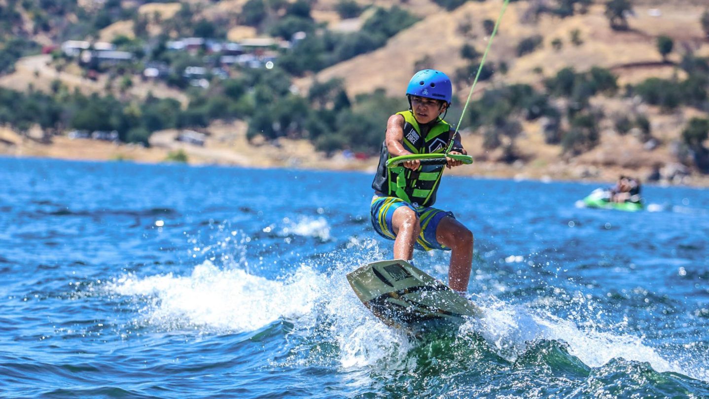 A camper learning how to wakeboard