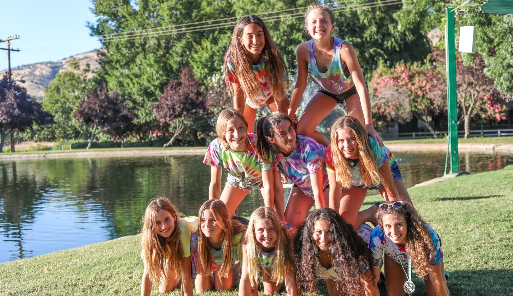 Campers posing for a group photo in a pyramid.