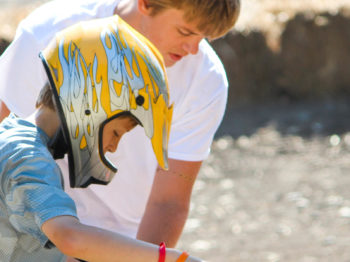 A camper getting ready to ride a mini bike